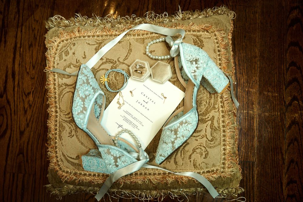 Wedding invitation cards with light blue ribbons on vintage textured background.