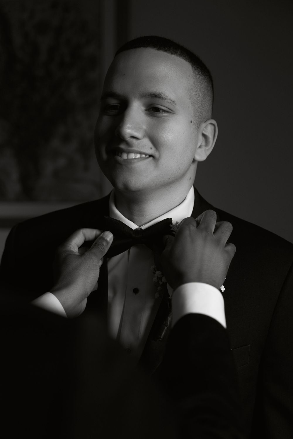 Formal black and white portrait with dramatic lighting and shadows.