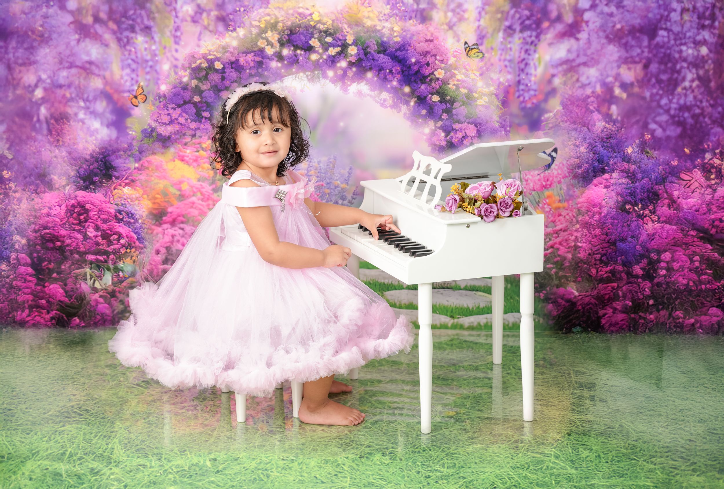 Magical outdoor photography scene with white piano against purple floral backdrop.