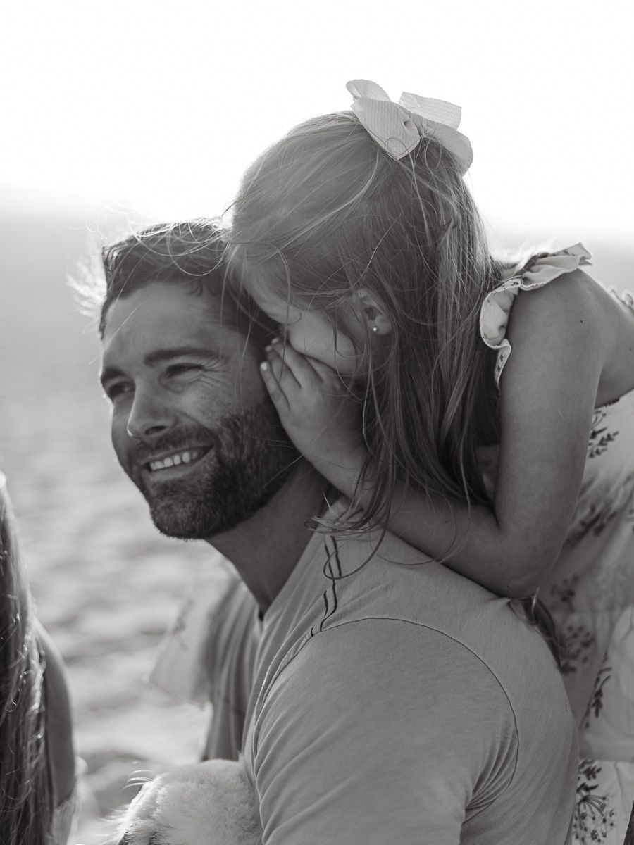 Intimate black and white beach portraits capturing candid romantic moments.