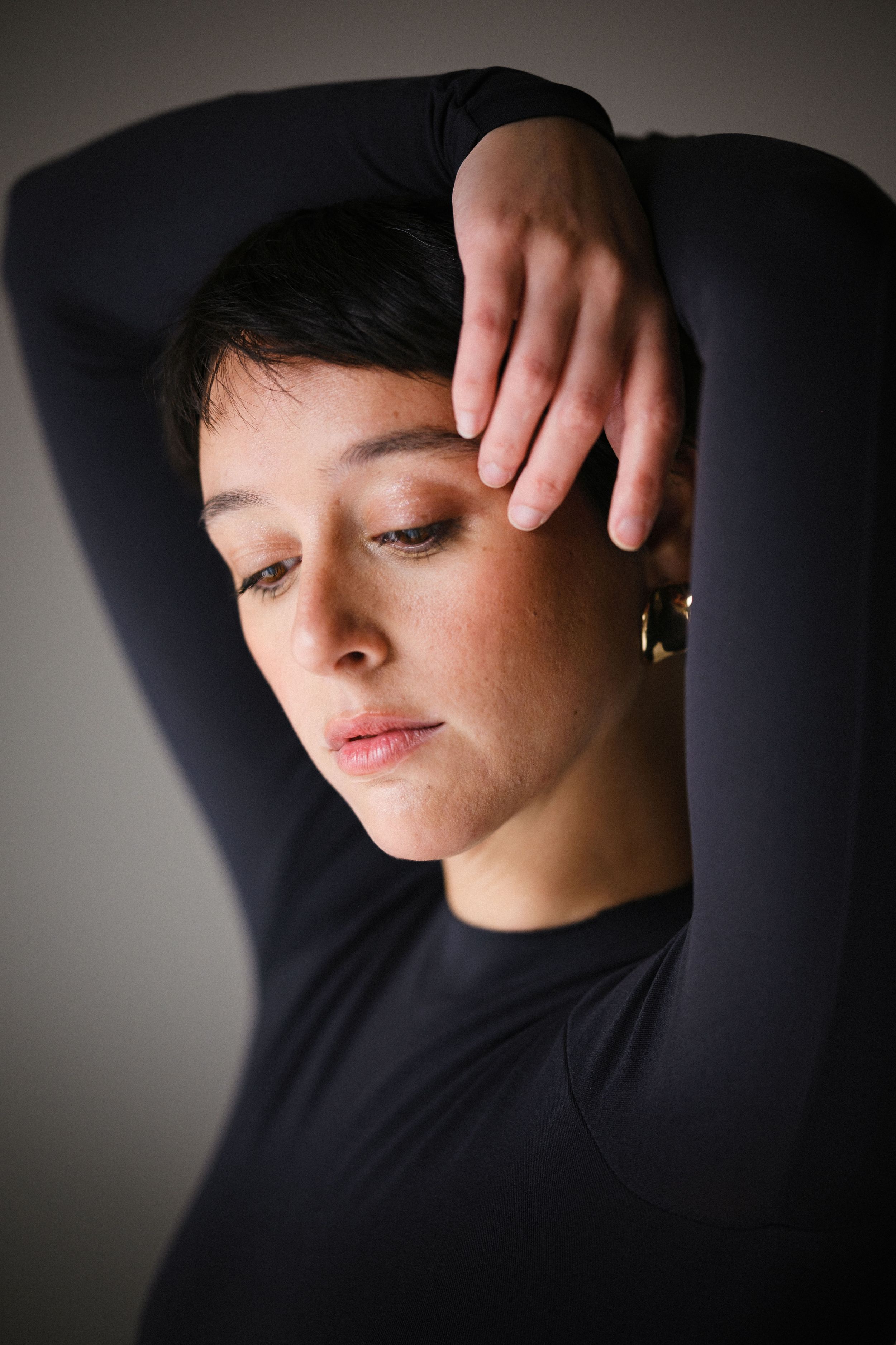 Moody portrait series with dramatic shadows and black turtleneck.