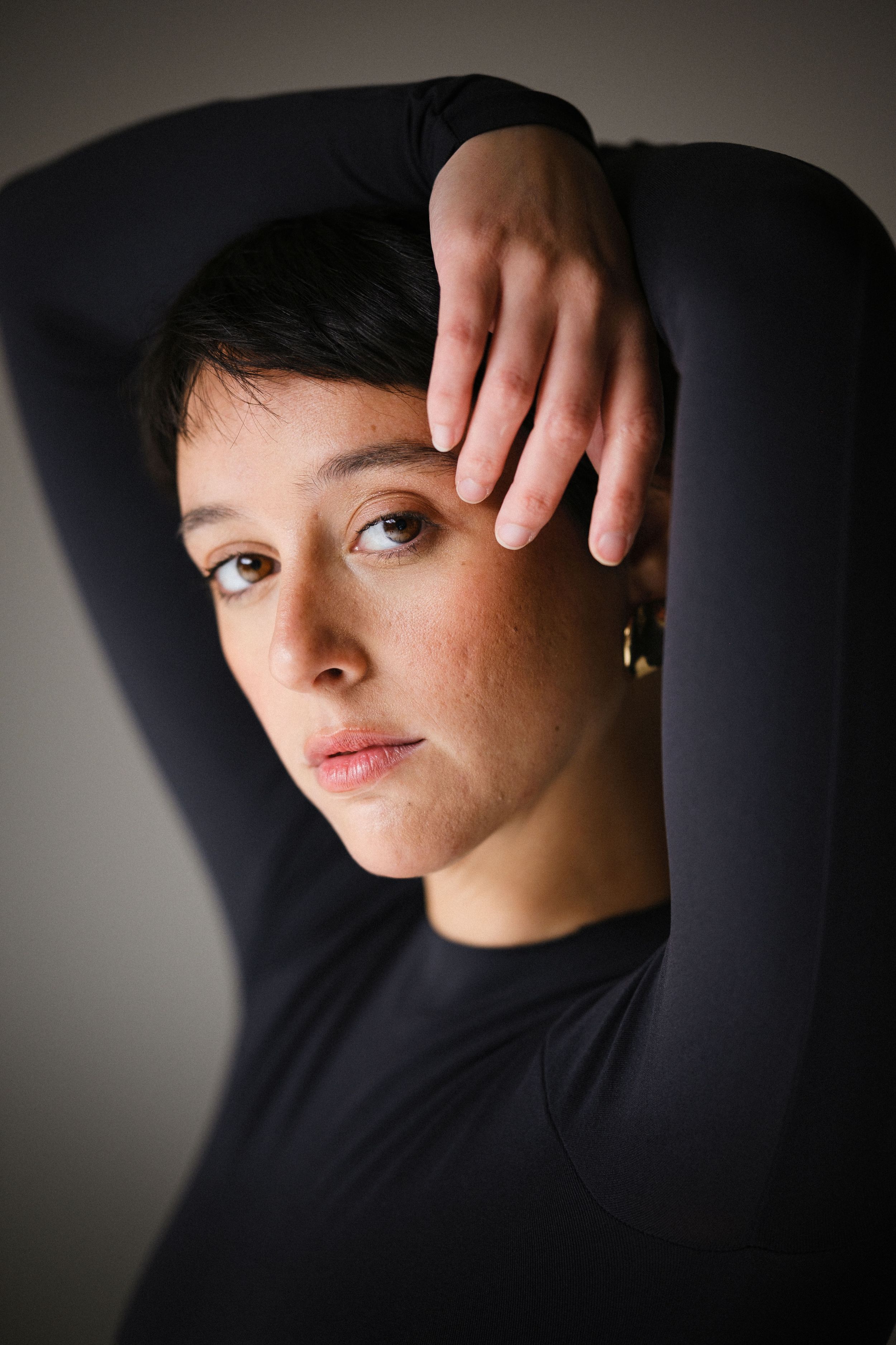 Close-up beauty shots with dramatic lighting and black top.