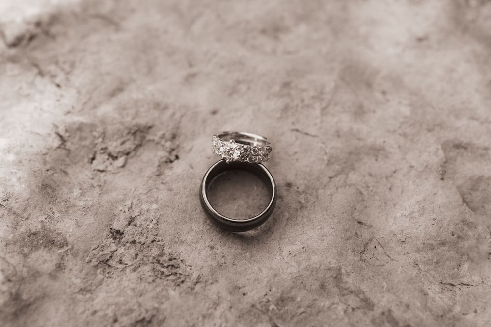 Simple wedding rings on stone, black and white for summer backyard wedding in Ohio photography by Vicci Photo Dayton Ohio Photographer