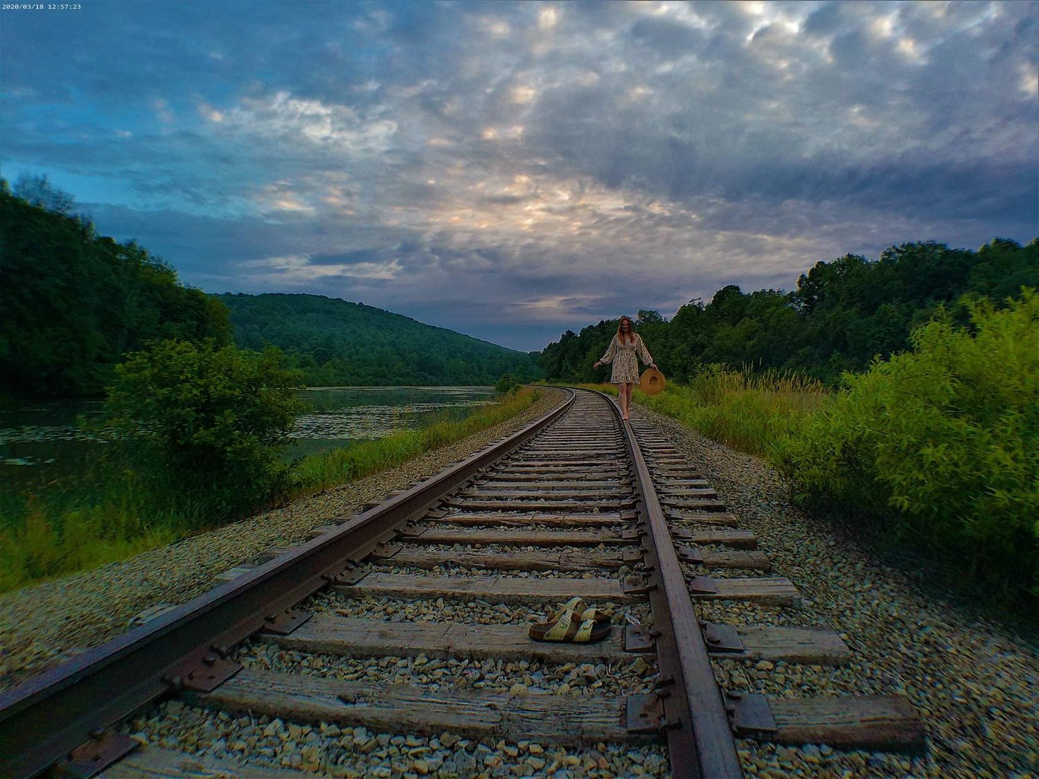 Railroad tracks stretching into the distance under dramatic cloudy skies.