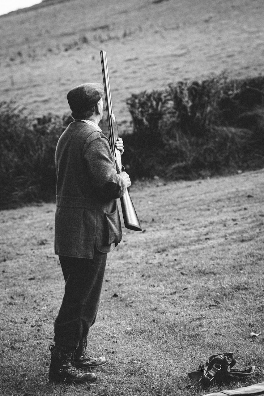 Pheasant shooting reportage photo of gun shooting high birds over exmoor