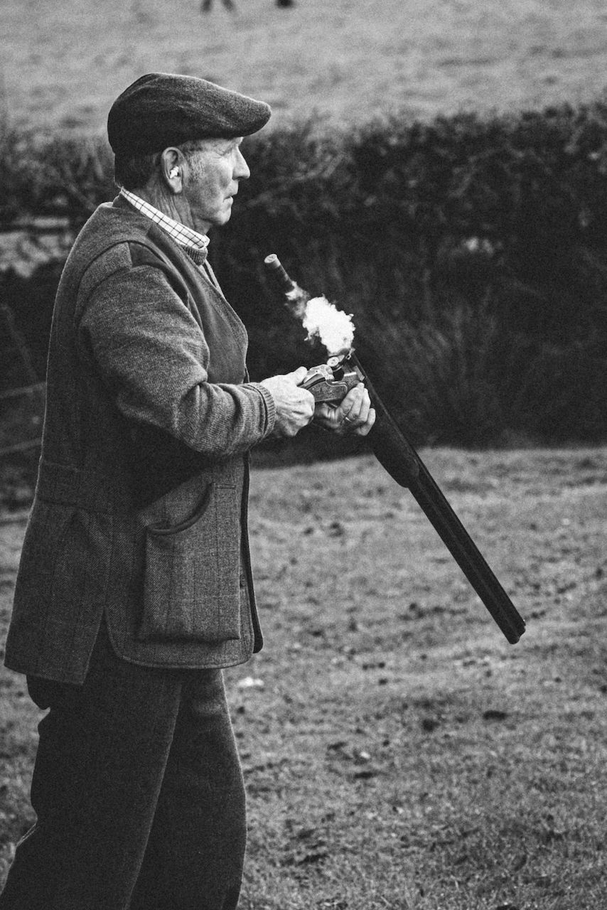 Pheasant shooting reportage photo of gun ejecting spent shotgun cartridges