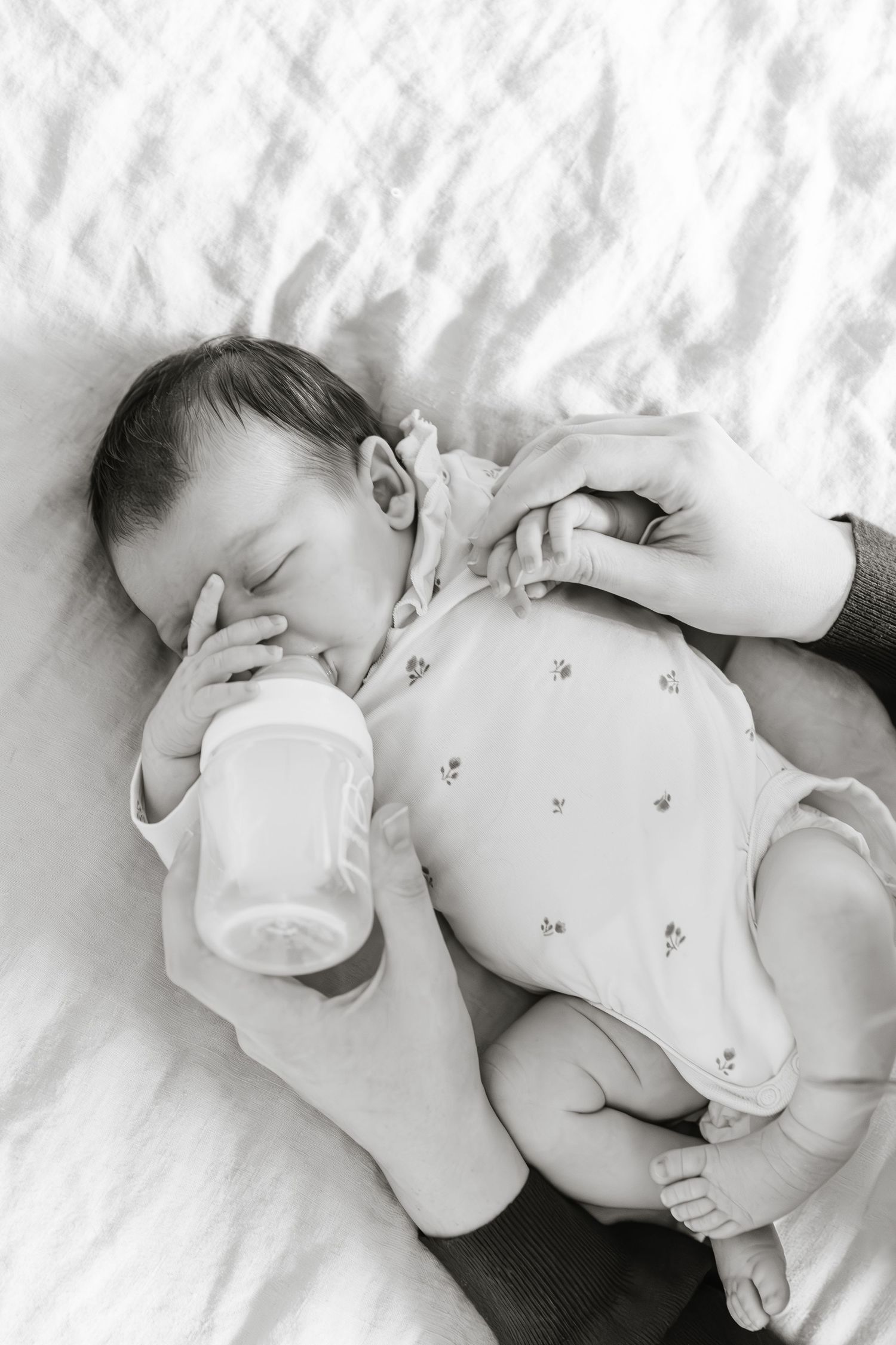 Black and white baby photos taken at home for a bright and airy soft lighting lifestyle newborn photography photoshoot in Kelowna, BC.