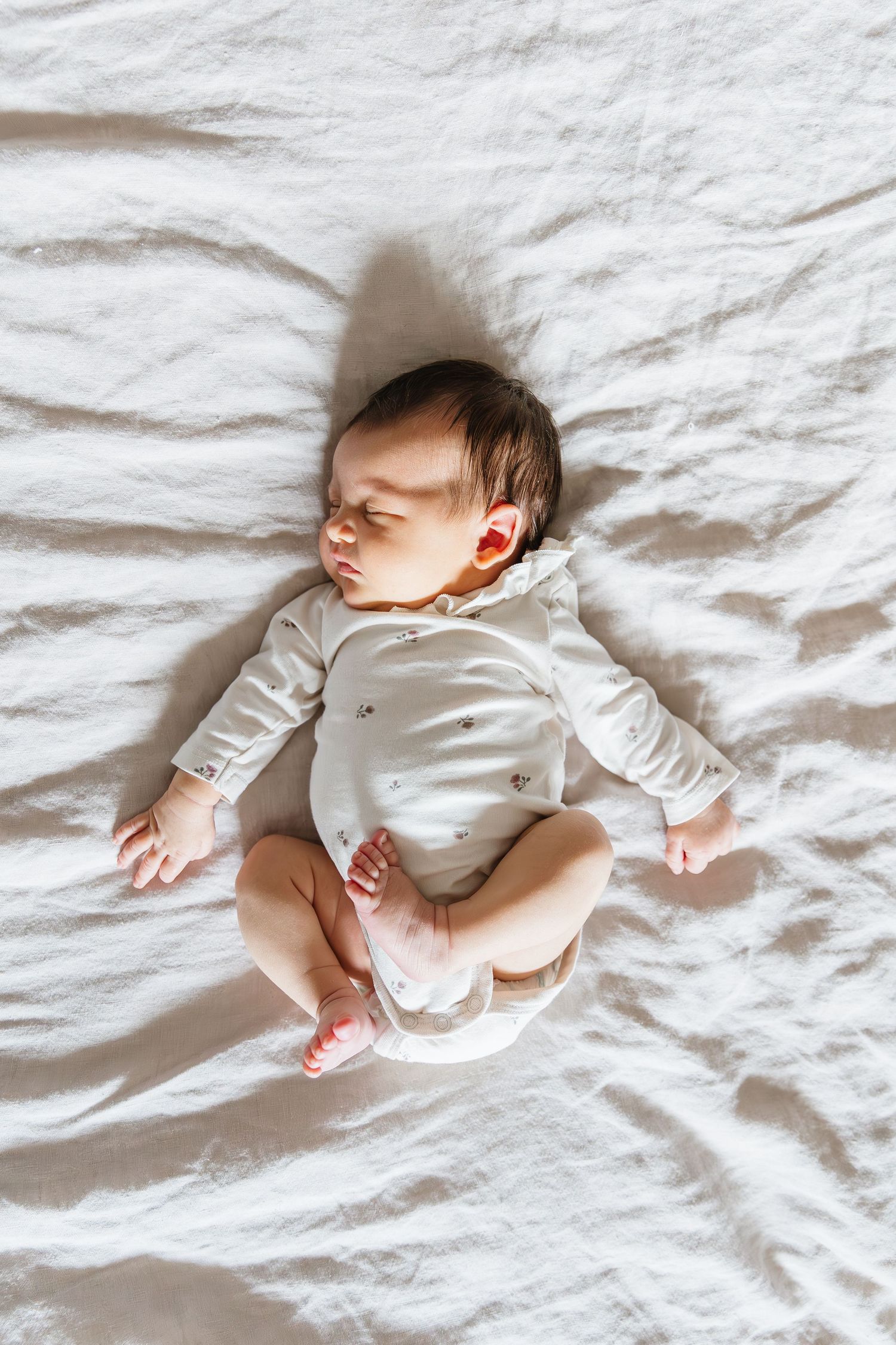 Sleeping Newborn baby photos taken at home for a bright and airy soft lighting lifestyle newborn photography photoshoot in Kelowna, BC.
