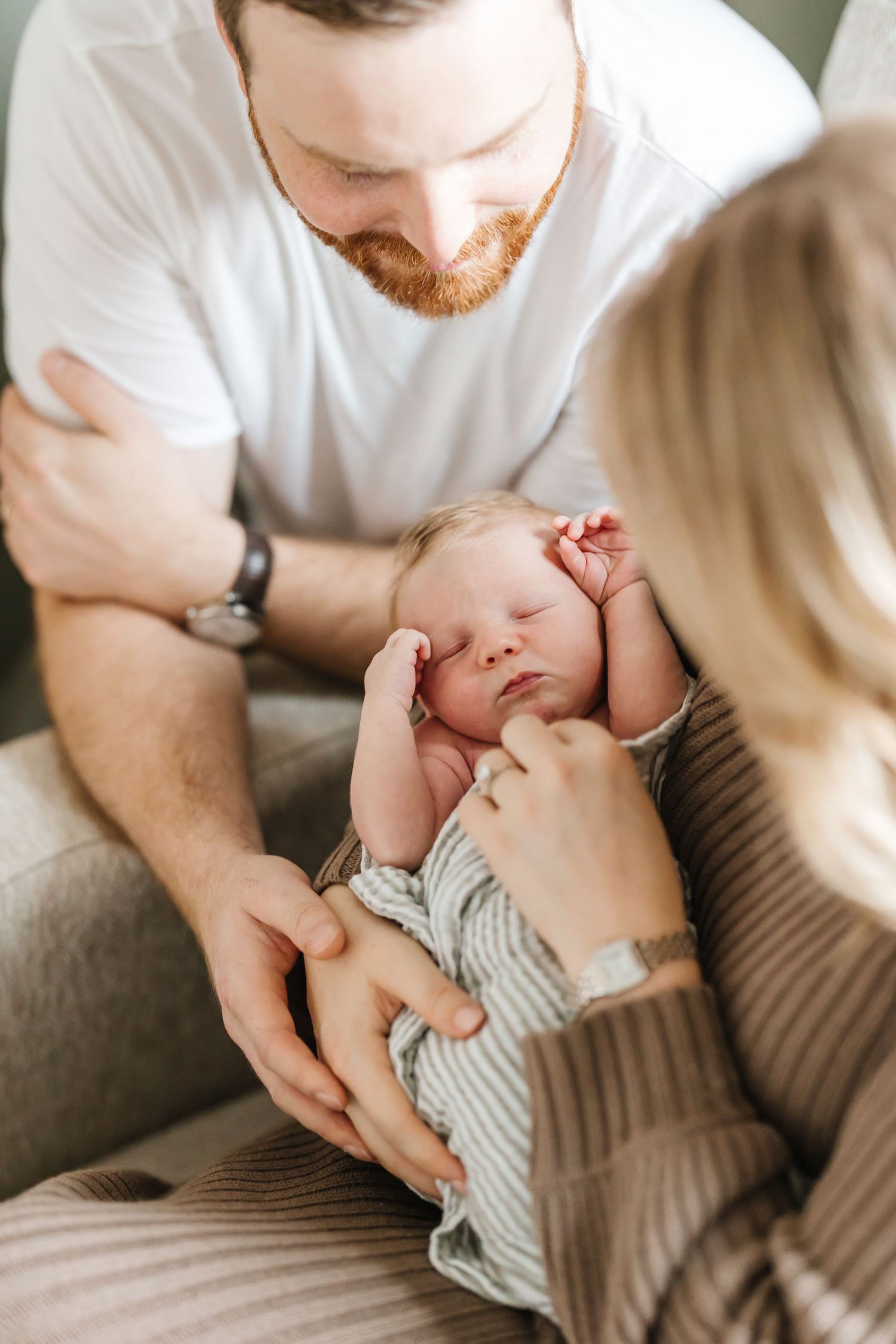 A series of five intimate photos showing tender moments between a parent and baby in soft, natural lighting.