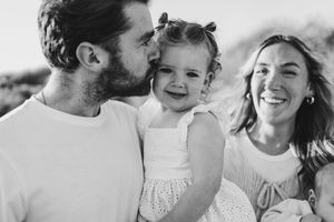 A joyful family moment captured in black and white showing intimate connection and laughter.