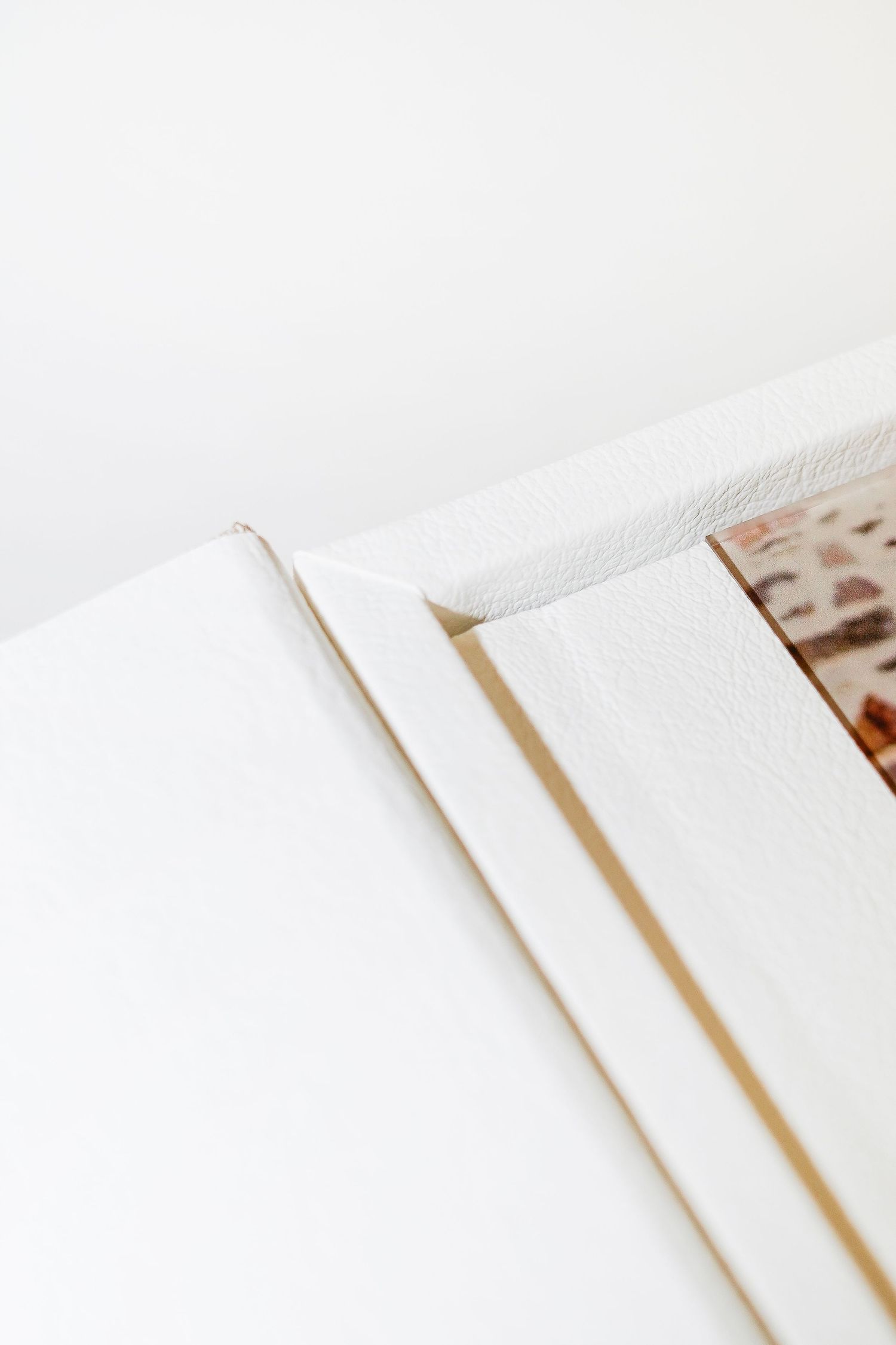 Detail shot of white pages in an album showing clean minimalist design.
