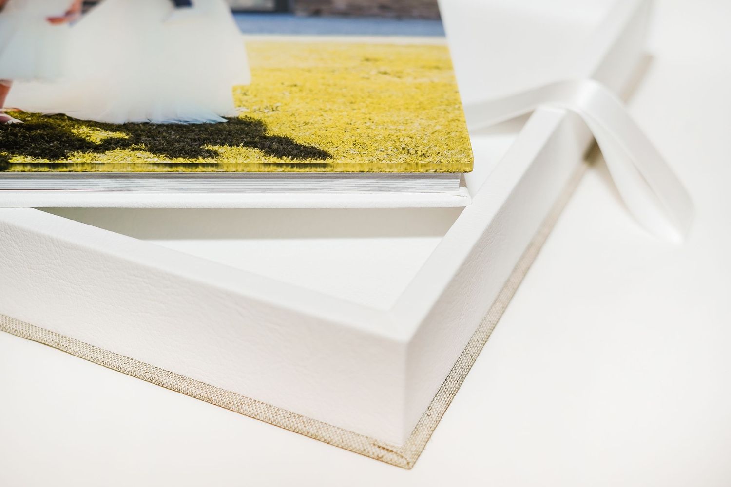 Wedding album showing layered white pages with professional binding.