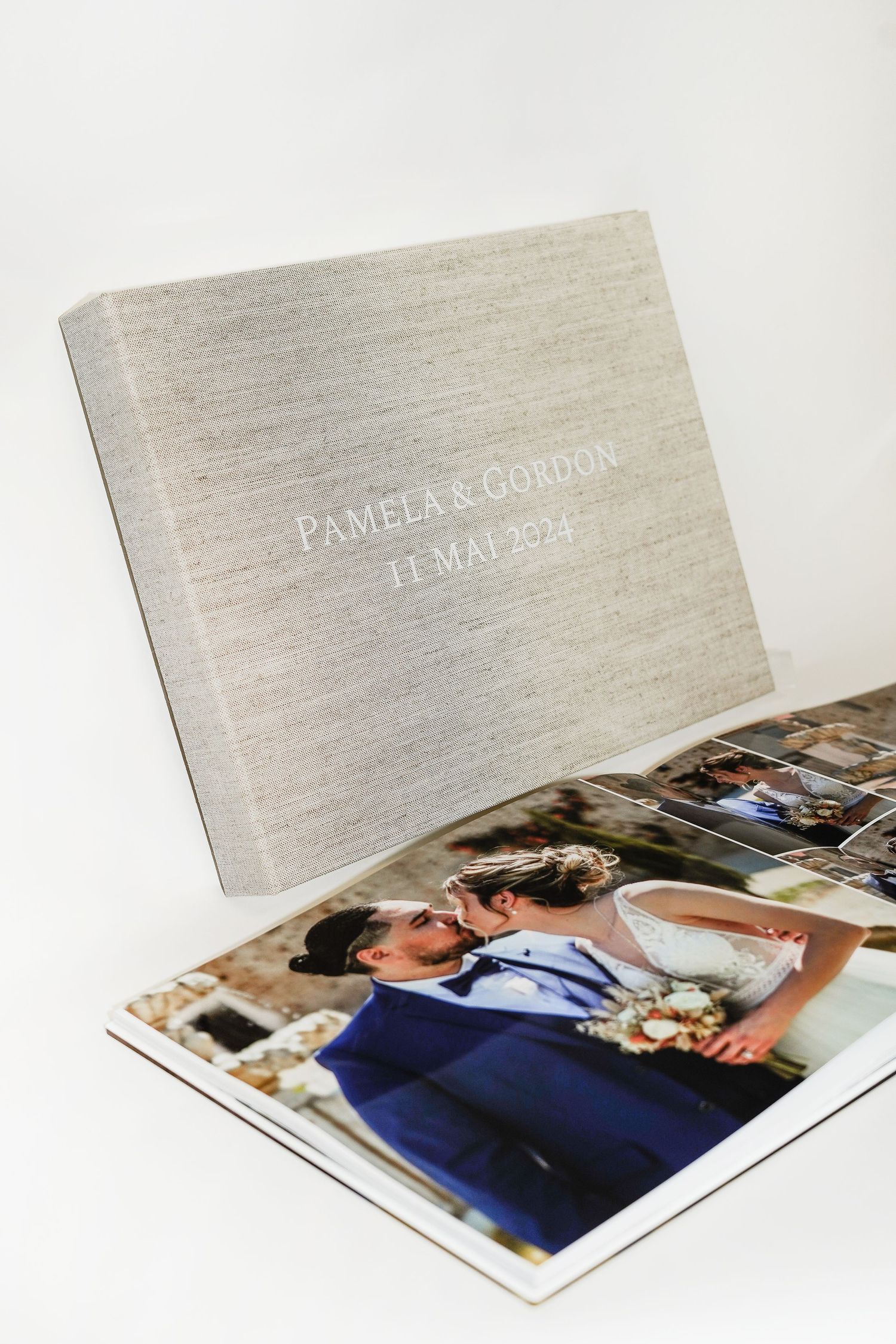 Grey linen wedding album cover with embossed text displaying date.