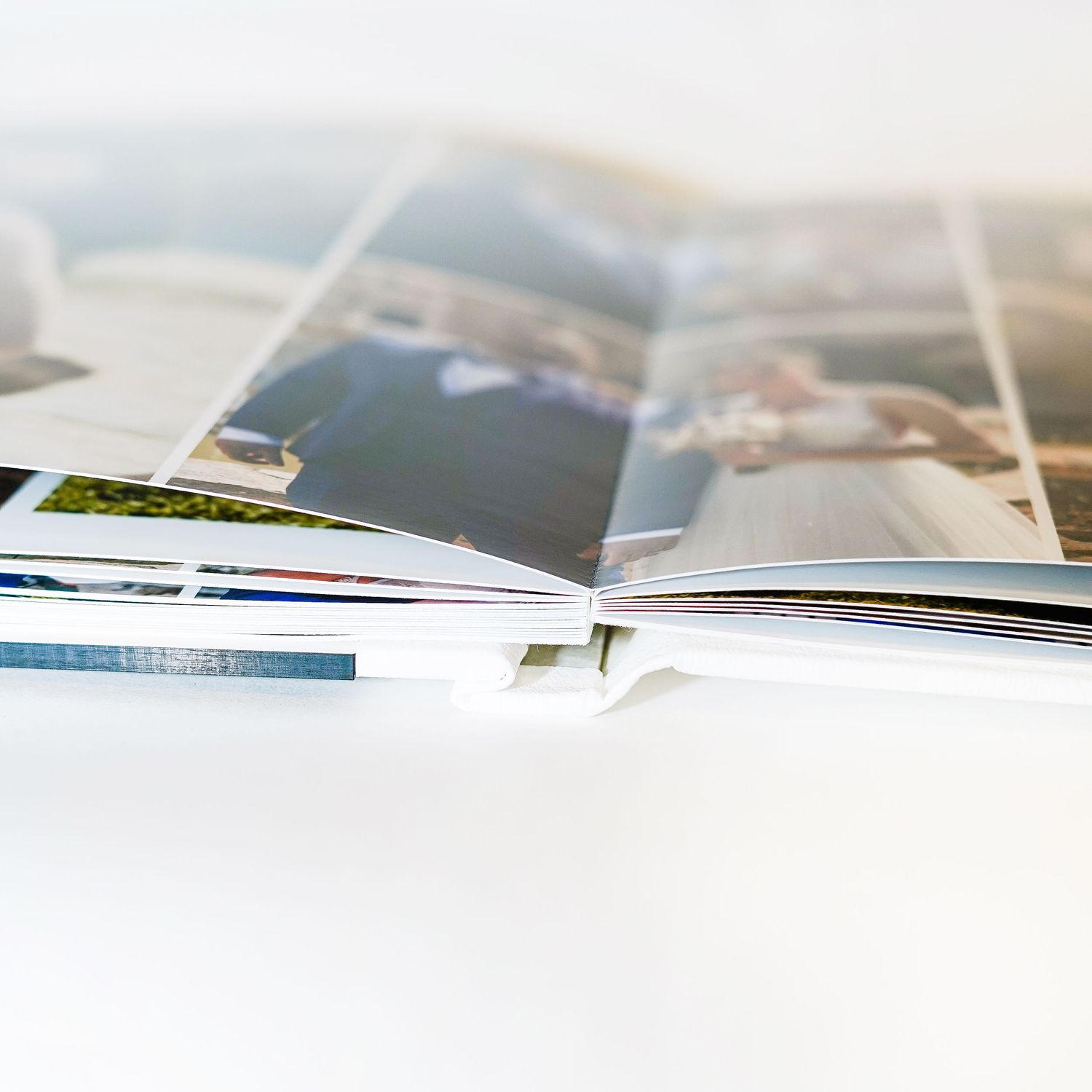Side view of an open wedding photo album showing layered page spread.