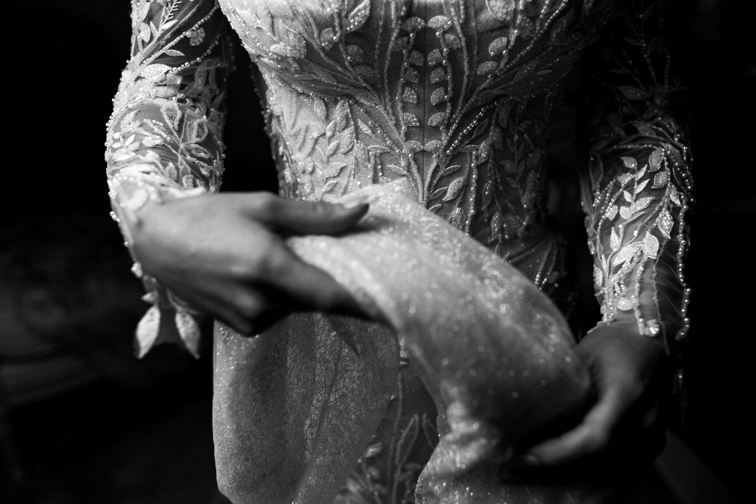 A black and white close-up photograph of a wedding dress. Bridal prep at Fairyhill