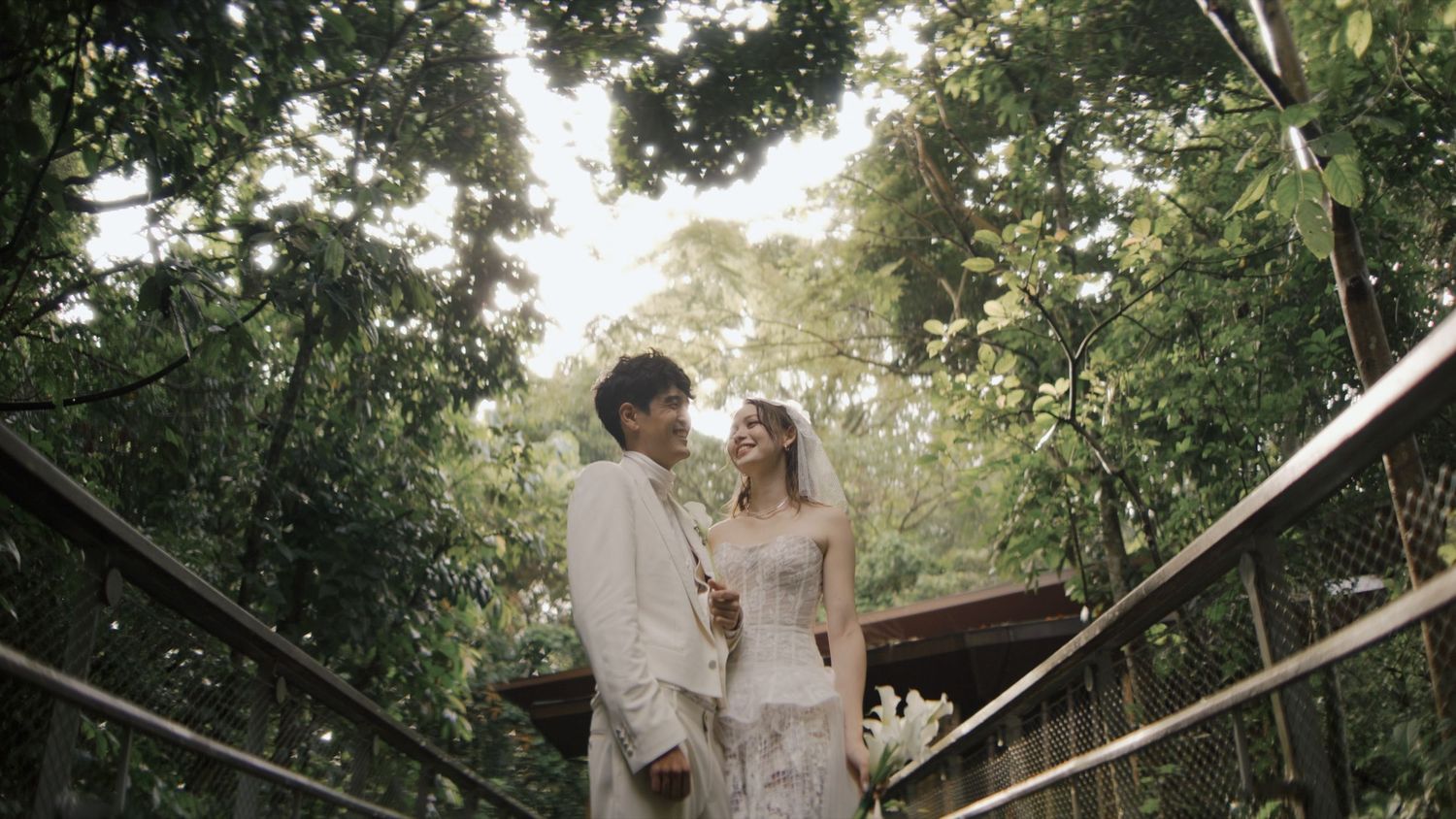 A romantic wedding moment captured outdoors with soft bokeh effect and natural lighting.