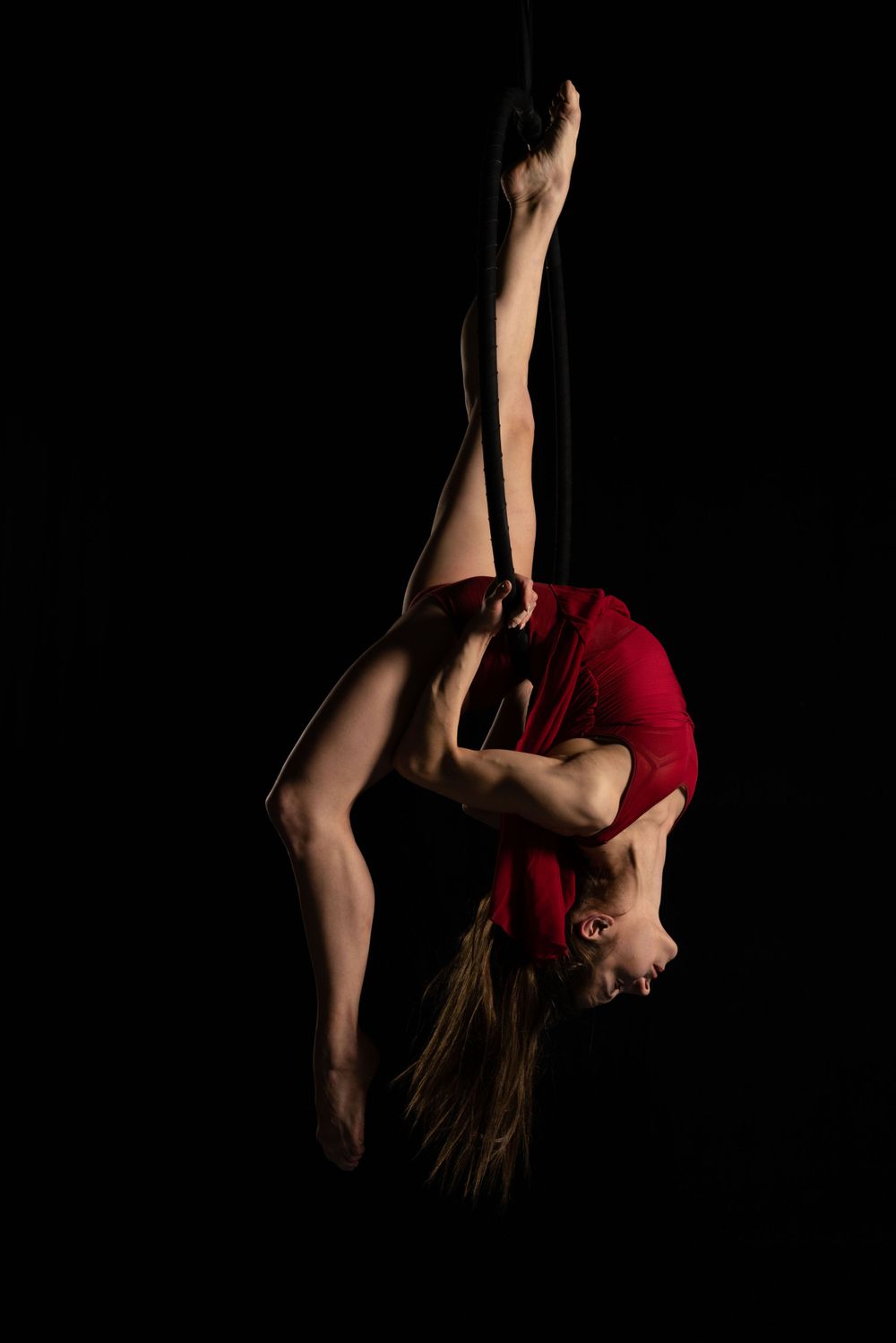 circus performer on a hoop using studio lighting