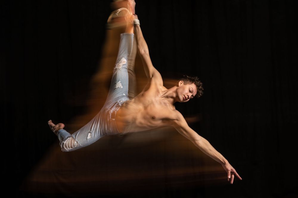slow shutter photo of a circus performer on straps