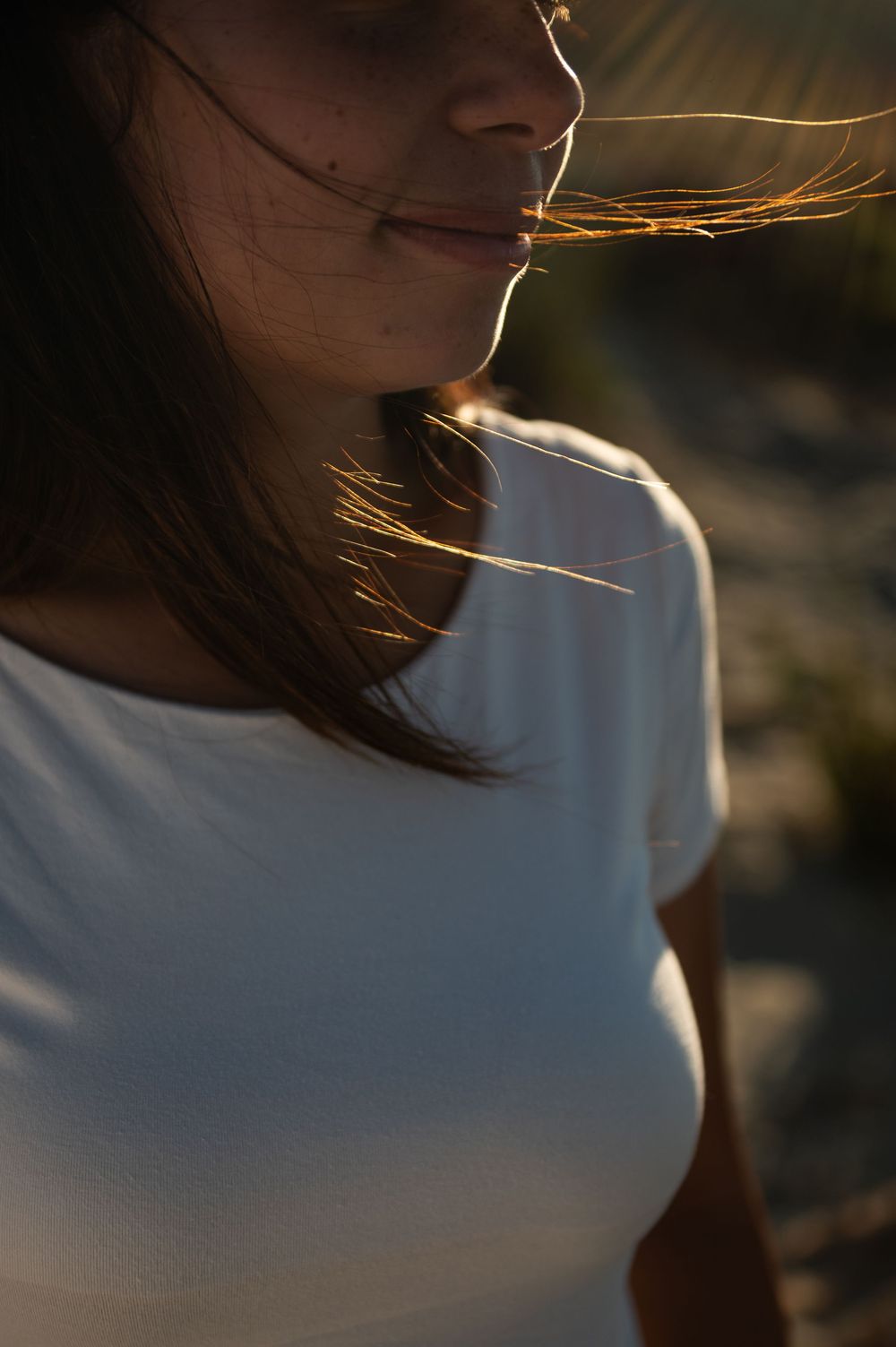 Artistic close-up portraits with backlit hair at golden hour.