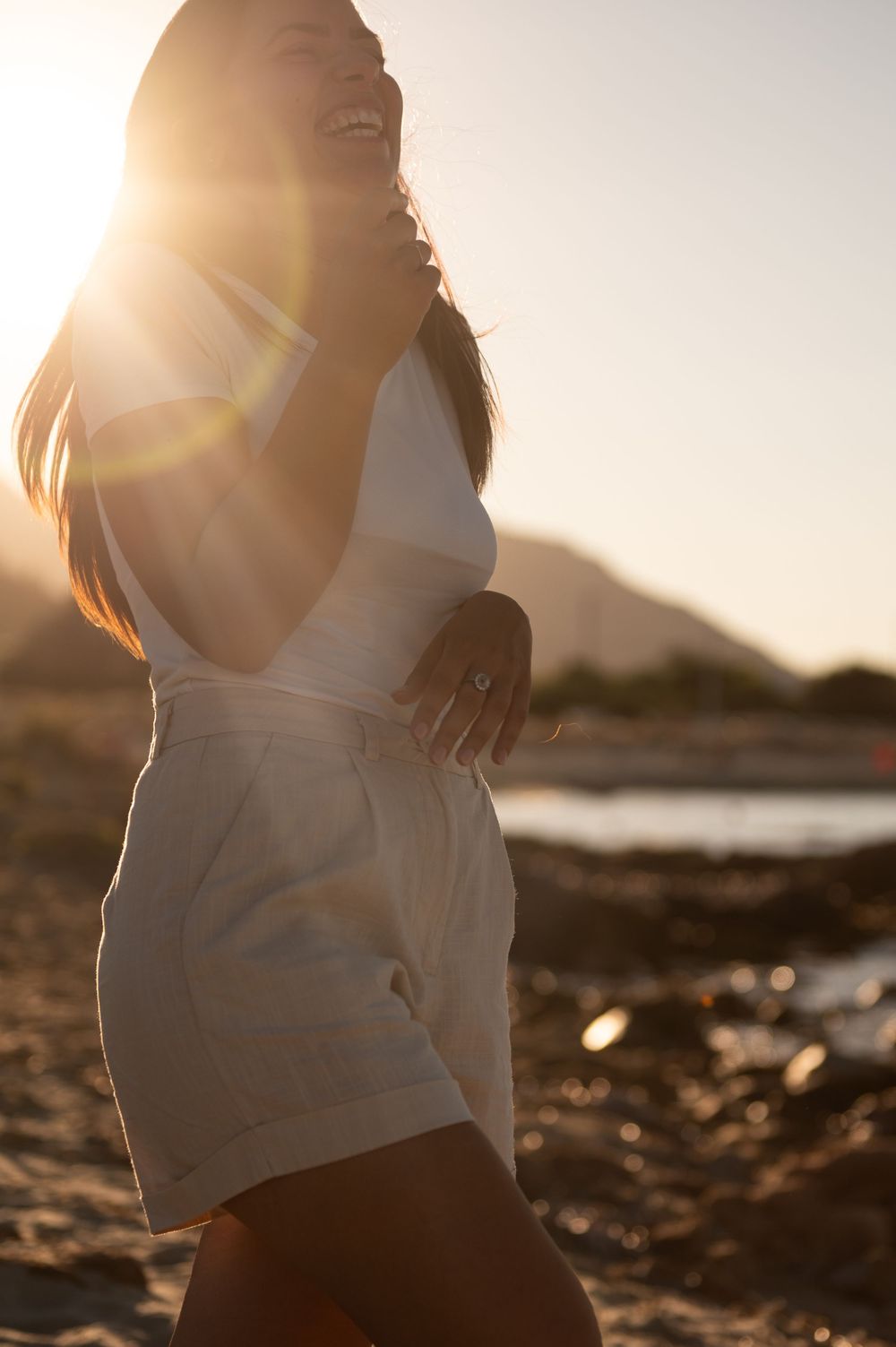 Maternity photos at sunset with golden light highlighting the baby bump.
