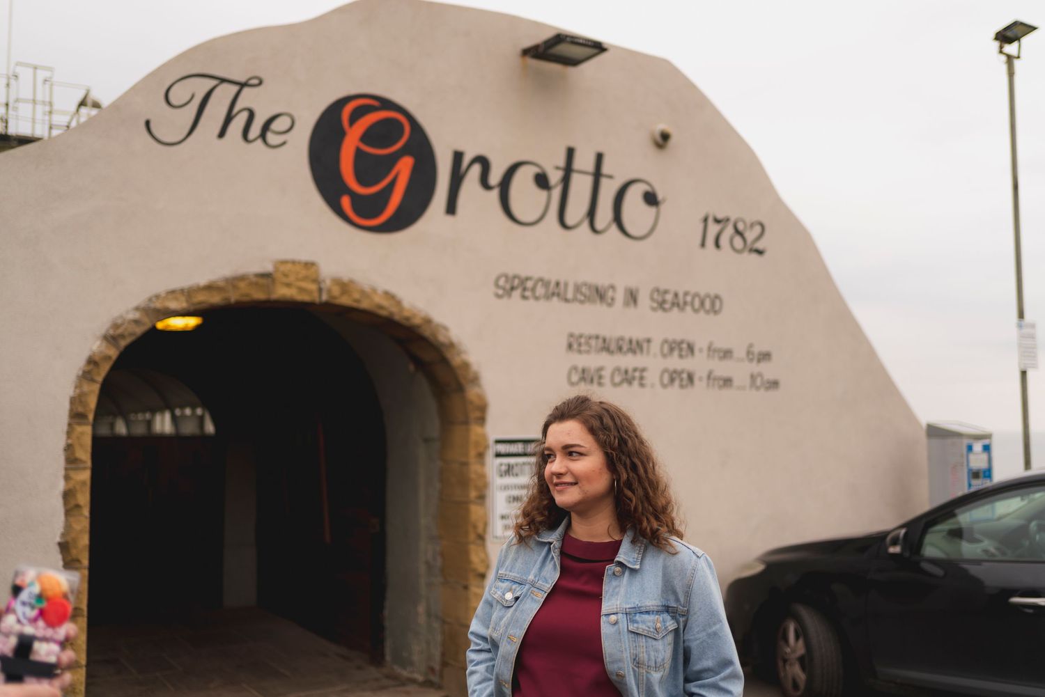 The exterior entrance of The Grotte establishment with its distinctive signage and architecture.