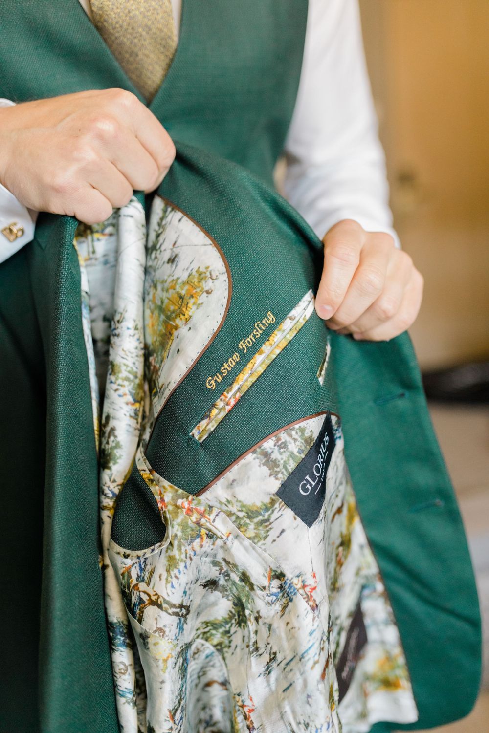 Close-up of a green suit jacket with decorative floral lining.