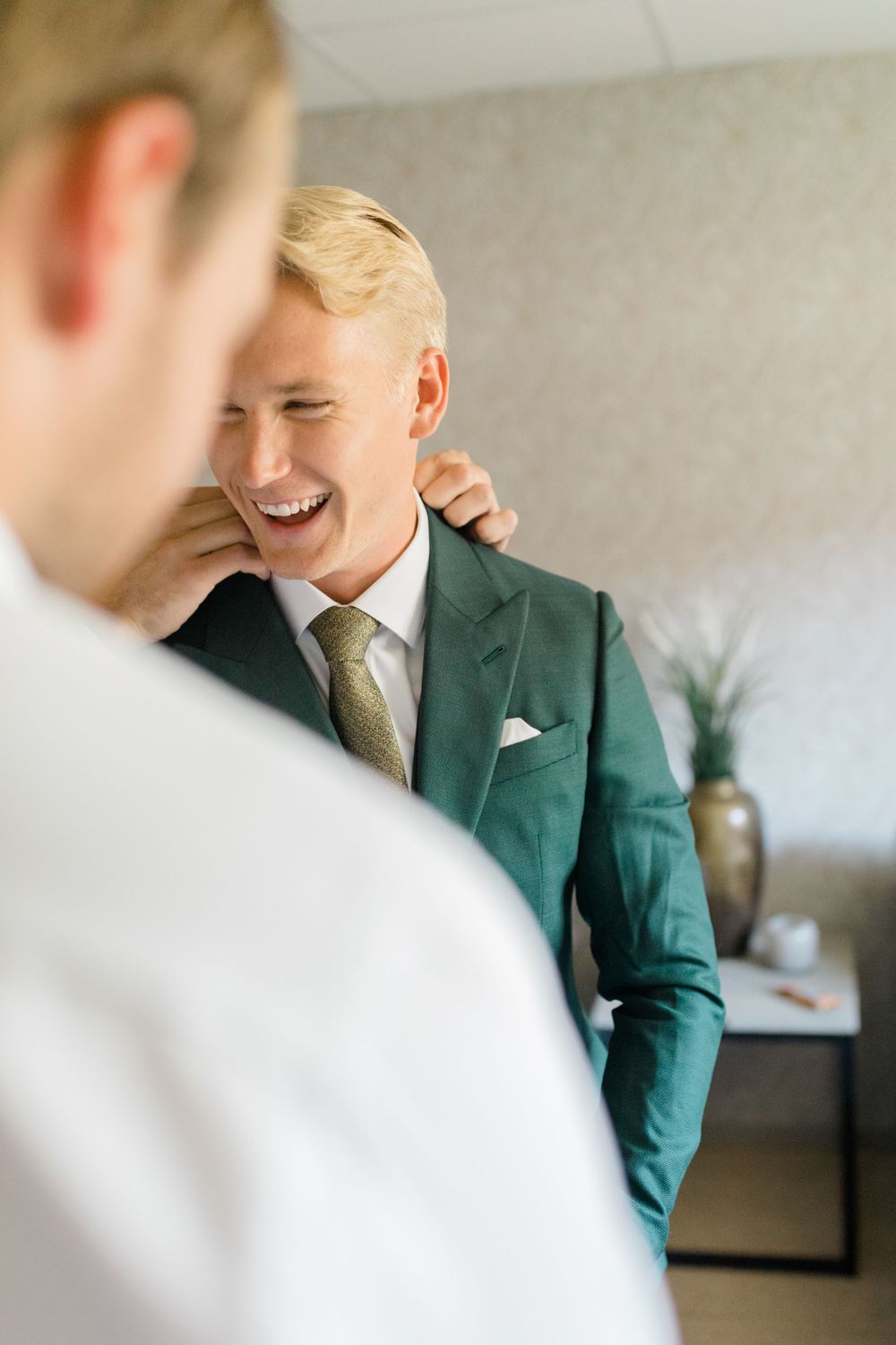 A joyful moment captured between people in formal attire.