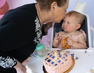 Close-up of baby's first birthday cake moment with decorated pastry.