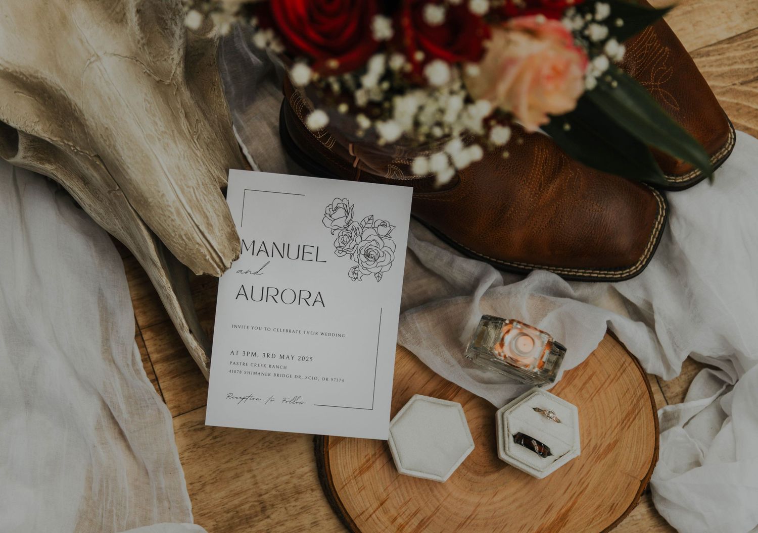 Black leather dress shoes next to a small glass perfume bottle and hexagonal containers on a light fabric surface.