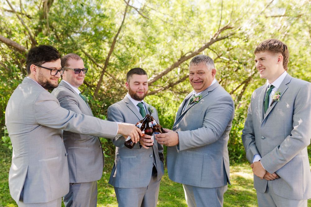 A series of candid moments with groomsmen in light grey suits sharing laughs in a sunlit outdoor setting.
