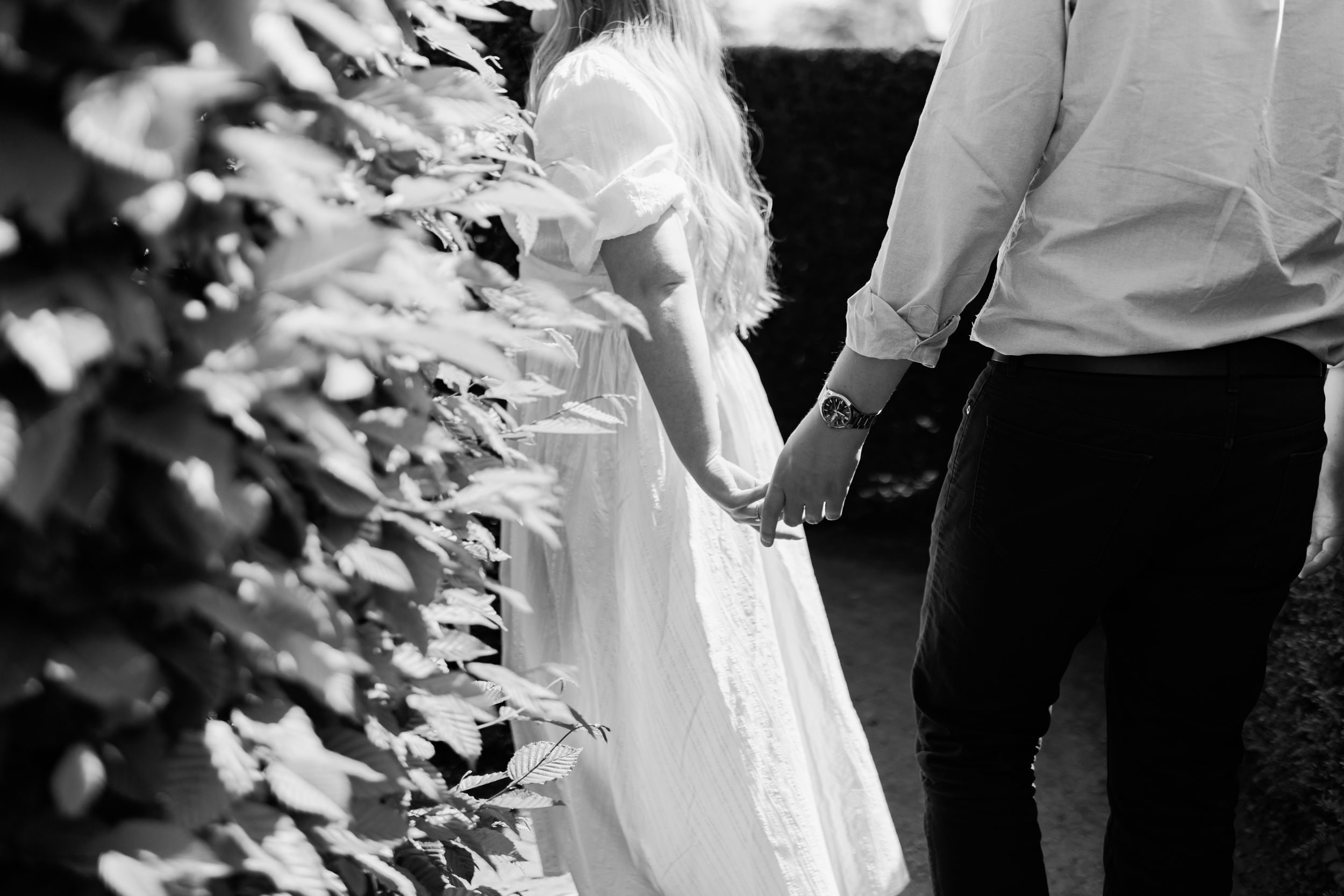 Black and white church wedding ceremony features a couple at the altar exchanging rings during their special day.