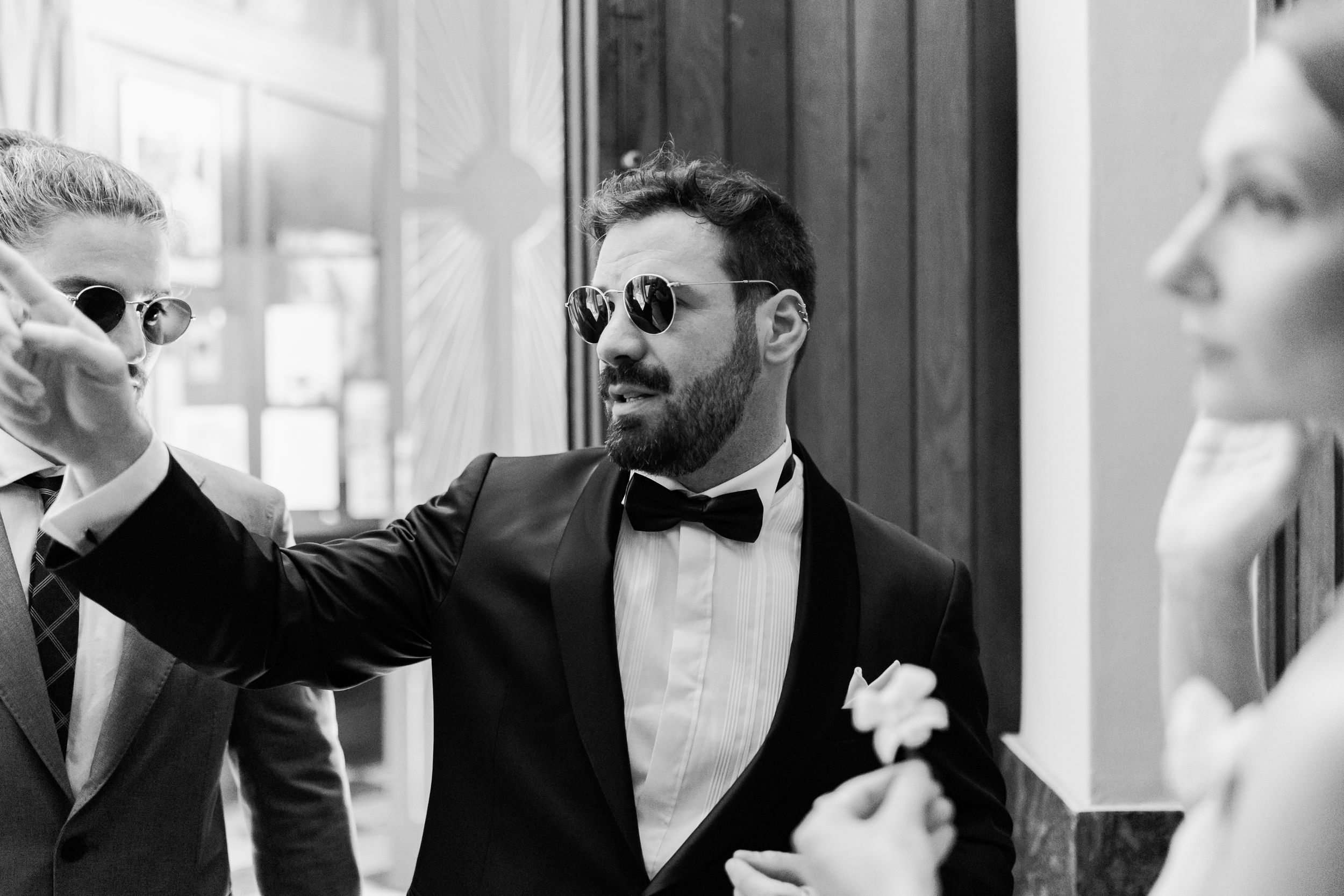 A monochromatic series of photos showing different suited men in formal wear and sunglasses creating a collage effect.