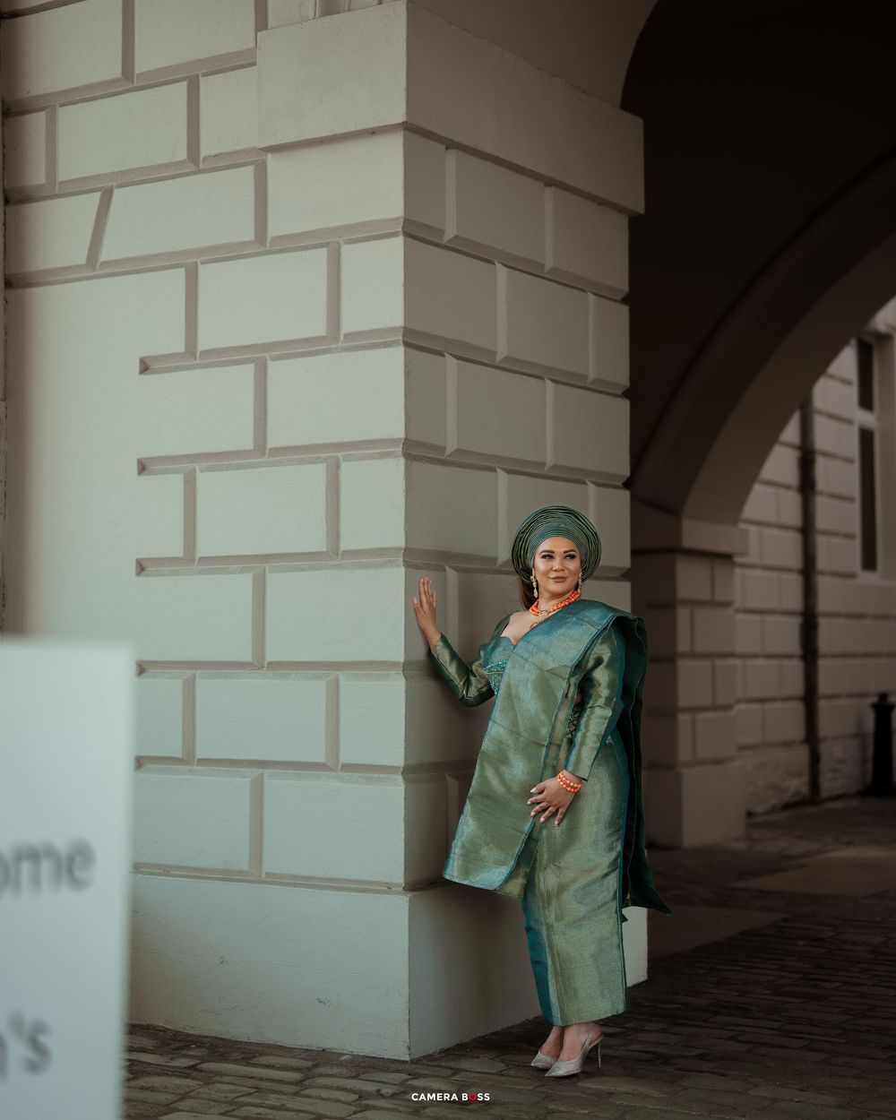 Artistic photo sequence showing a figure in teal clothing performing expressive movements against white pillars.