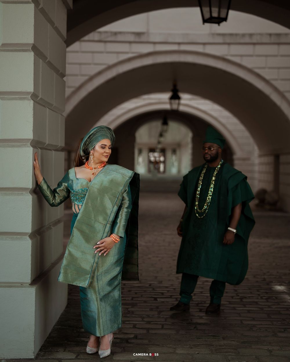 Dynamic dance performance captured in a series of poses under an arched colonnade.