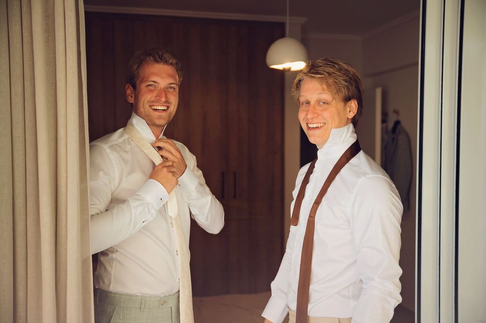Wedding preparation sequence showing adjustments to formal attire in indoor setting.
