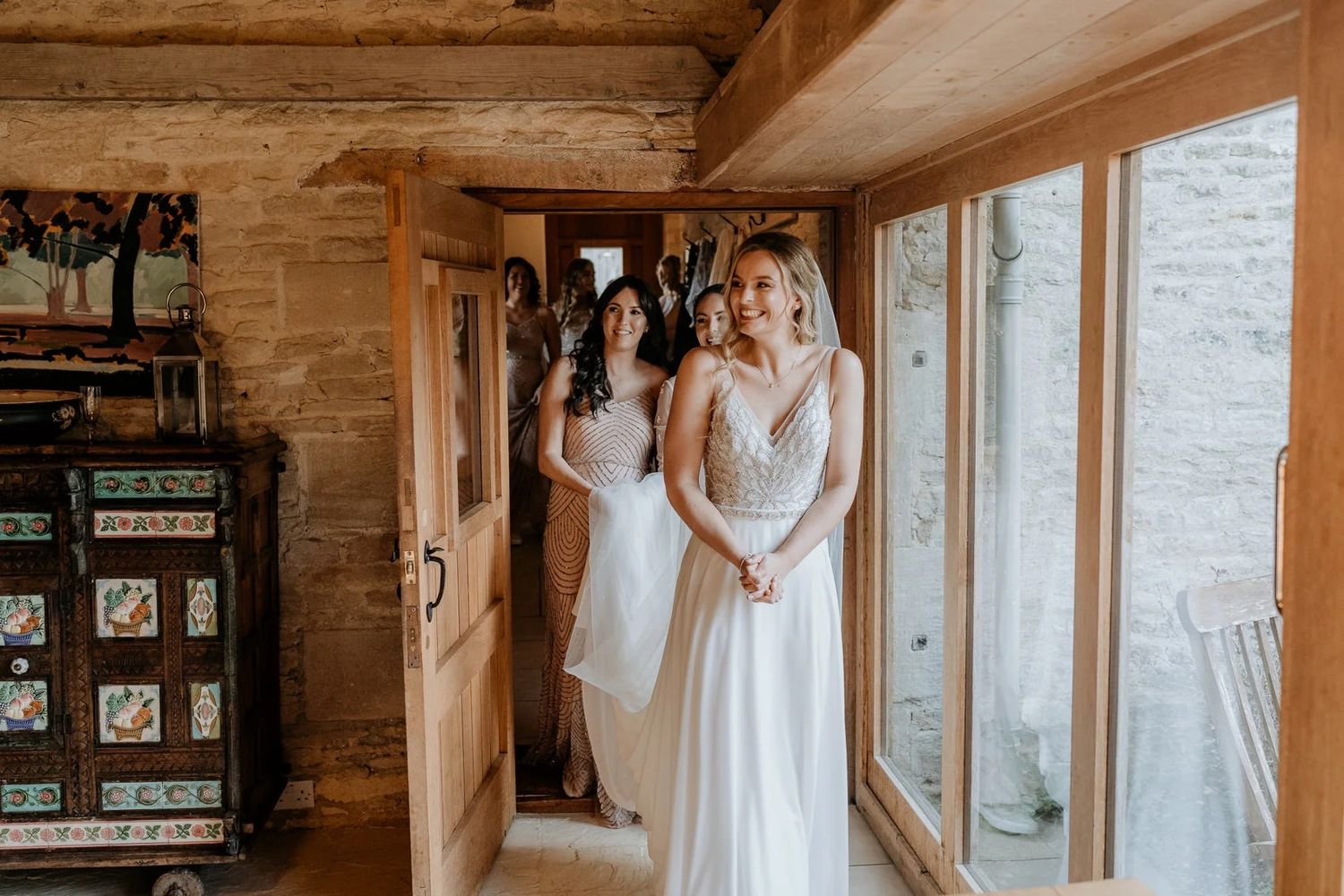 Rustic wooden interior with large windows and natural light streaming in.