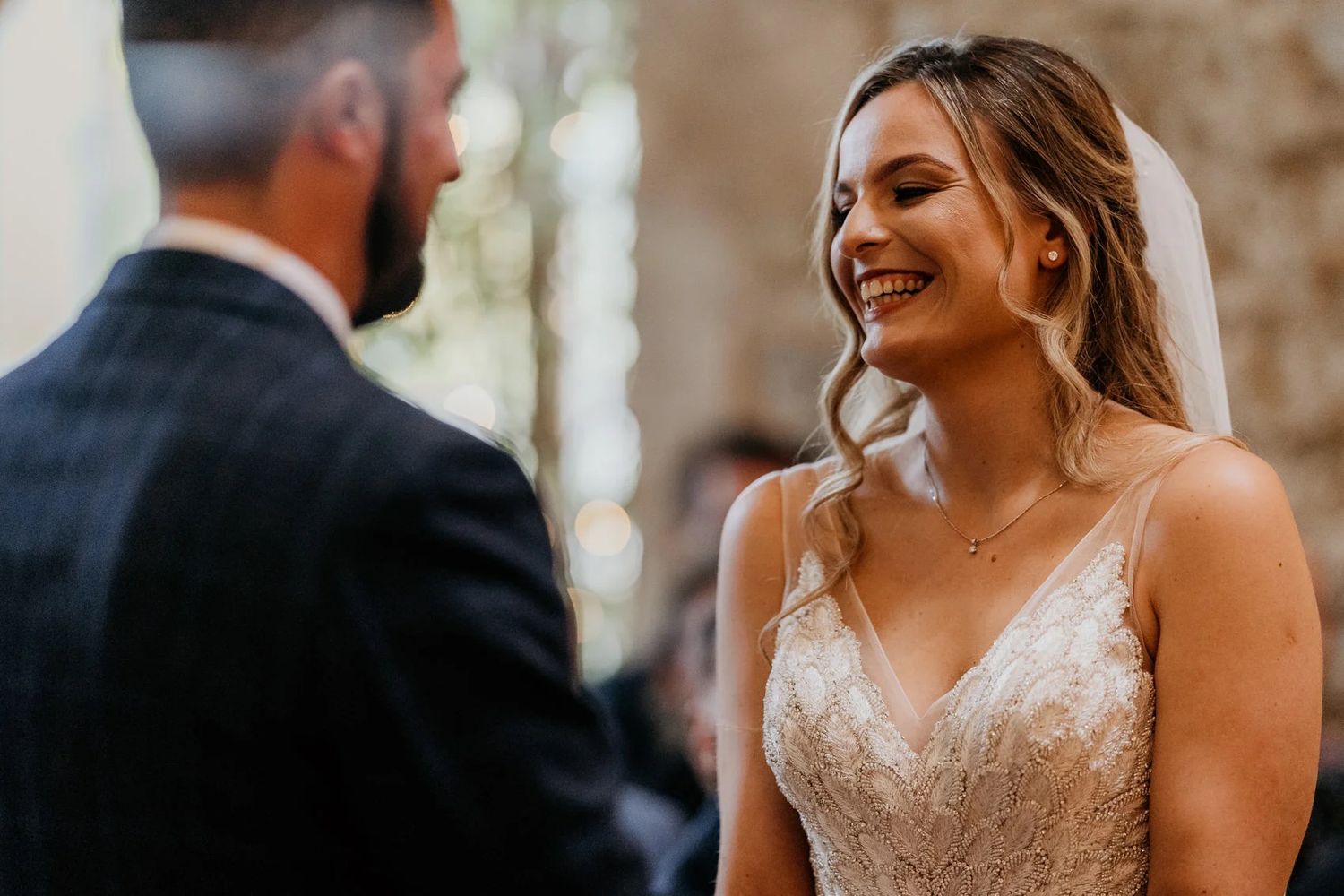 Wedding celebration candid moments captured in an elegant stone-walled venue.