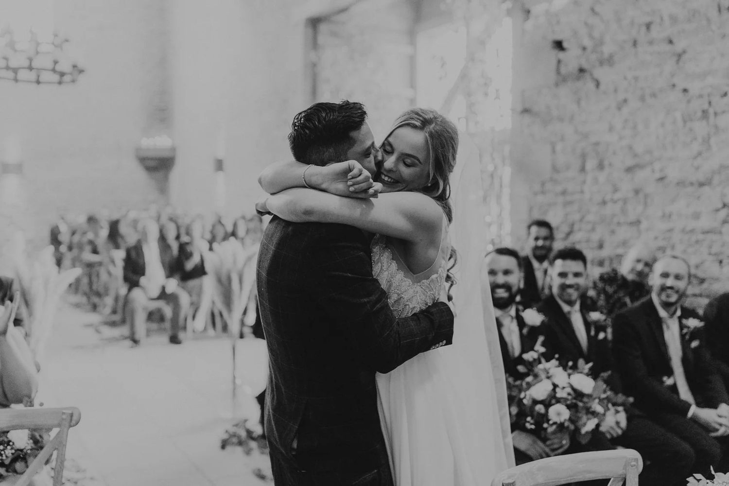 Black and white photo of a wedding ceremony with guests in attendance.