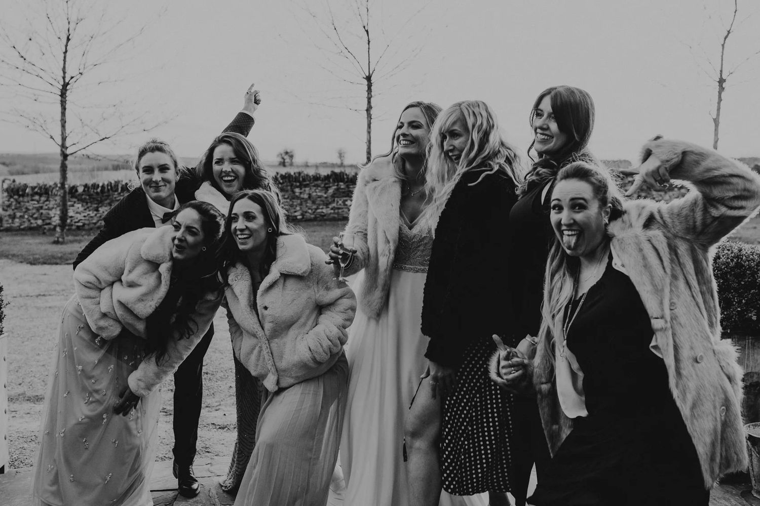 Group of wedding guests enjoying an emotional outdoor celebration filled with laughter and joy.