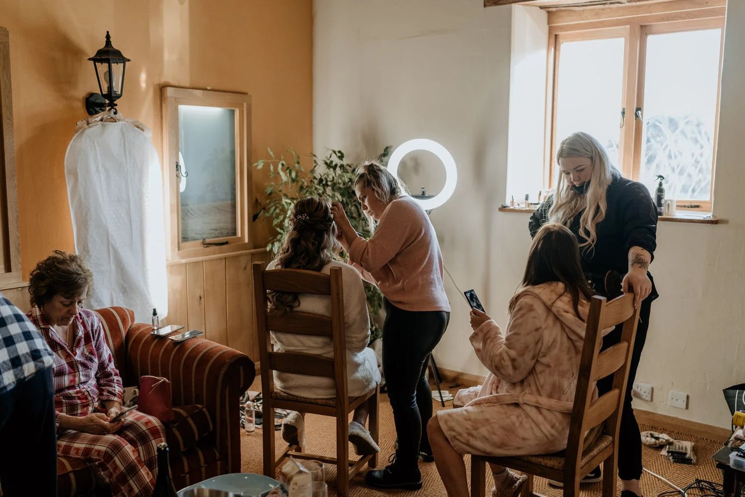 Interior scene with warm lighting and rustic furnishings during wedding preparations.