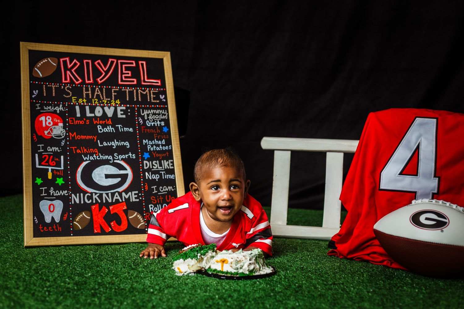 Football themed decorations and signs displayed outdoors on grass field.