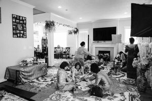 A panoramic black and white photo collage shows multiple views of a cluttered living room interior with furniture and decor.