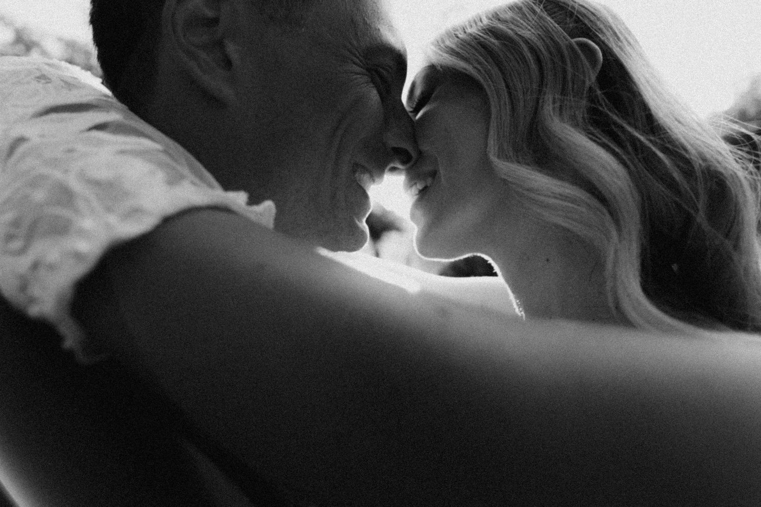 A black and white photo series showing a couple sharing an intimate romantic kiss sequence.