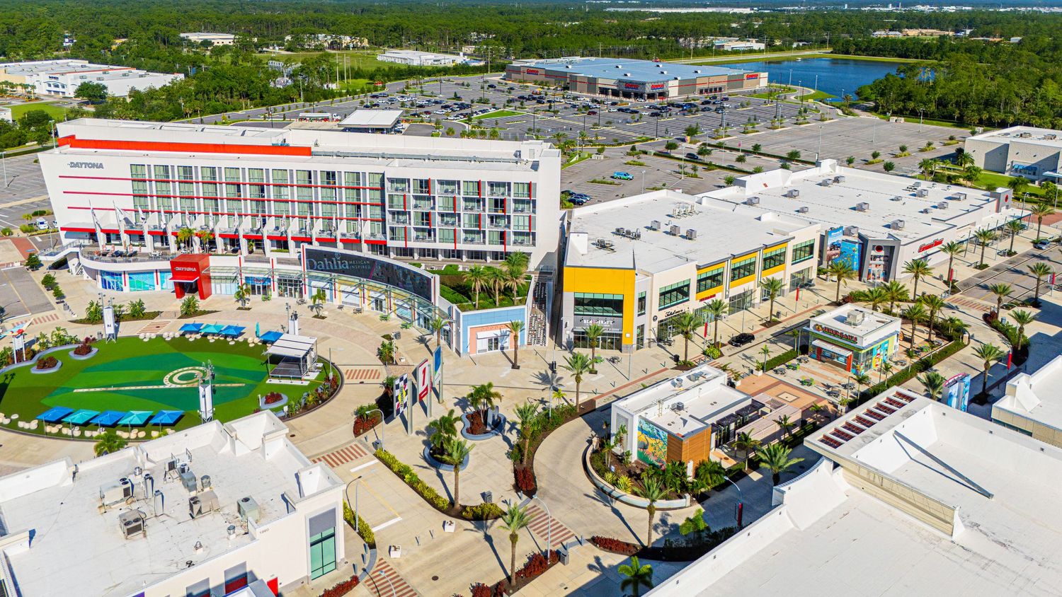 Panoramic aerial view of a coastal resort complex with beach access and amenities.