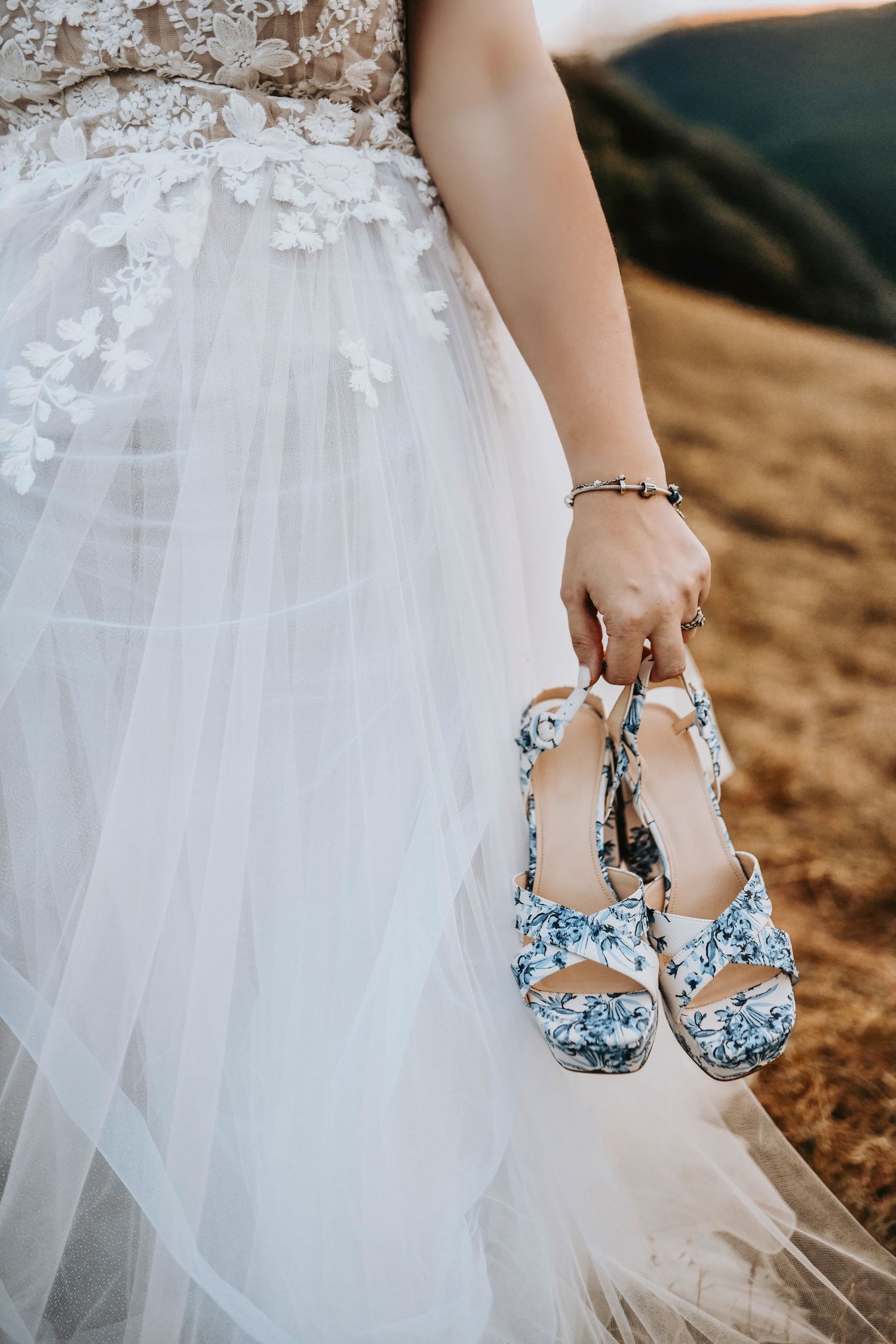 Blonde bride wearing vintage heels and delicate embroidered veil in Corinth, Texas countryside.