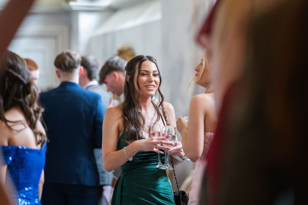 Guests mingling and socializing at an elegant indoor reception.