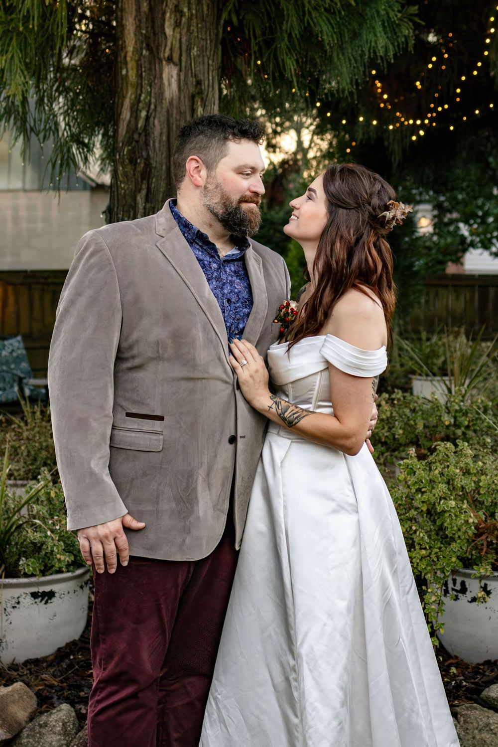 a close up portrait of a bride and groom smiling at each other