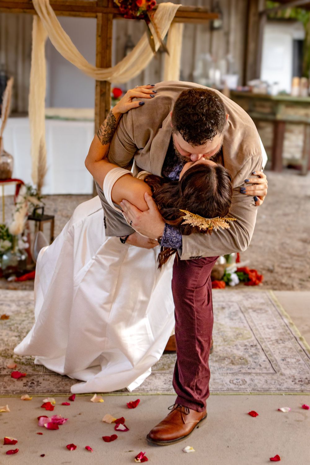 a bride and groom kissing at the alter