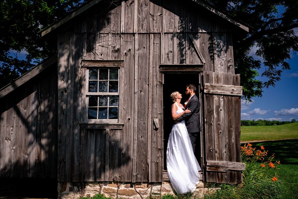 Wedding photography sequence near rustic wooden barn with wildflowers in foreground.