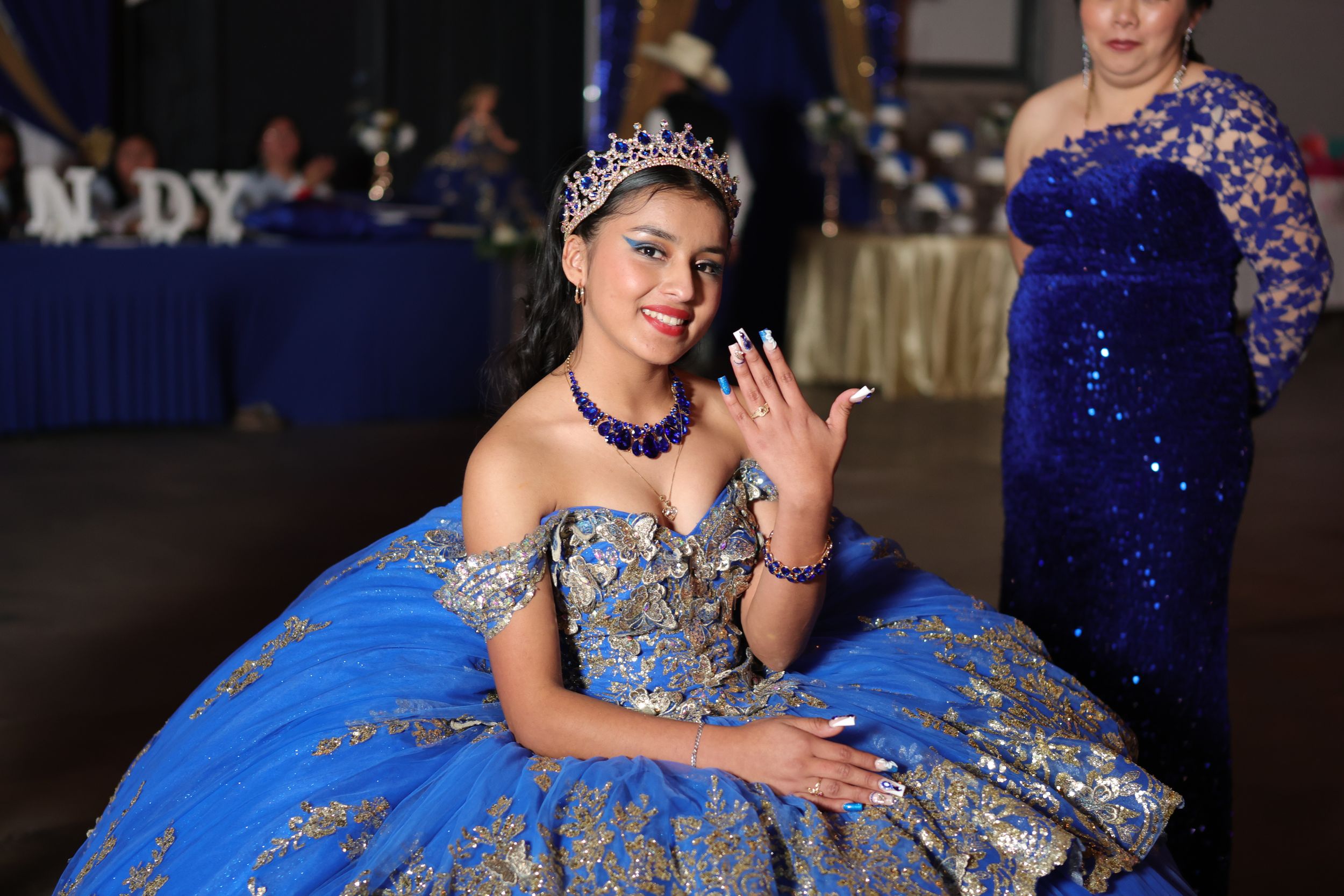 Quinceanera photo collage shows celebration with royal blue ball gown, tiara, and elegant poses at special event.